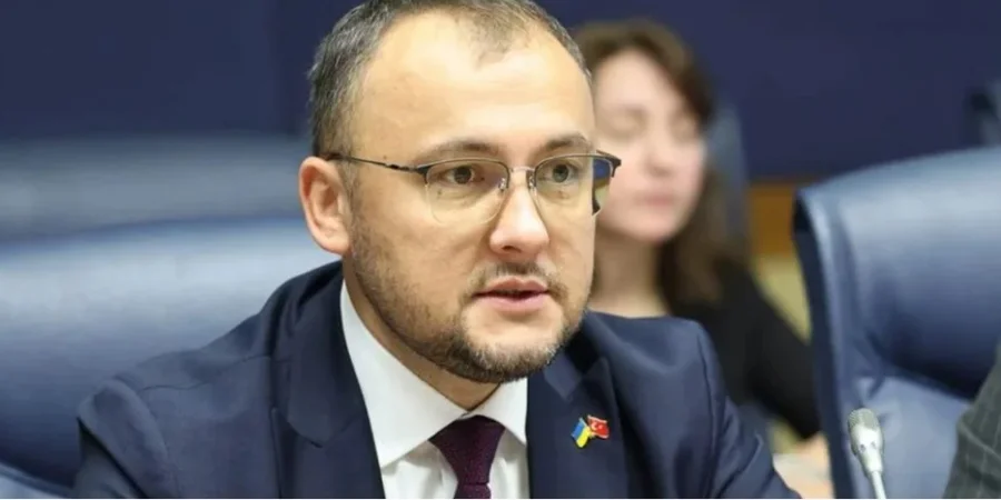 Ukraine’s Ambassador to Poland Vasyl Bodnar speaks into a microphone during a meeting.