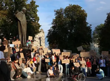 Demonstrators beneath the Taras Shevchenko monument in Lviv hold handwritten cardboard signs during an open-ended protest calling for Mykhailo Fedorov's reinstatement as Ukraine's Minister of Defence. Photo: Solomiia Stanovych/Euromaidan Press.