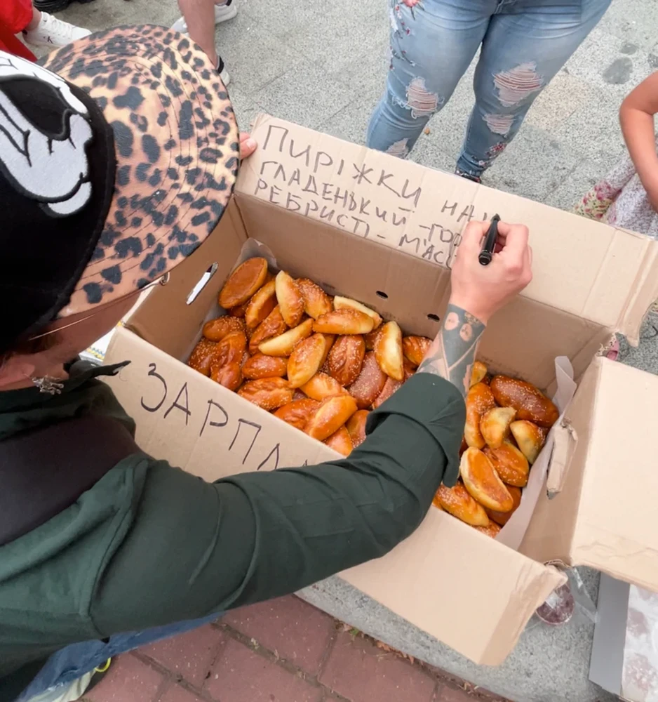Caption: A box of pastries brought to the protest by participants so anyone could grab a symbolic snack. The word “Salary” is apparently written on the side of the box. Photo: Sofiia Sereda / BBC.