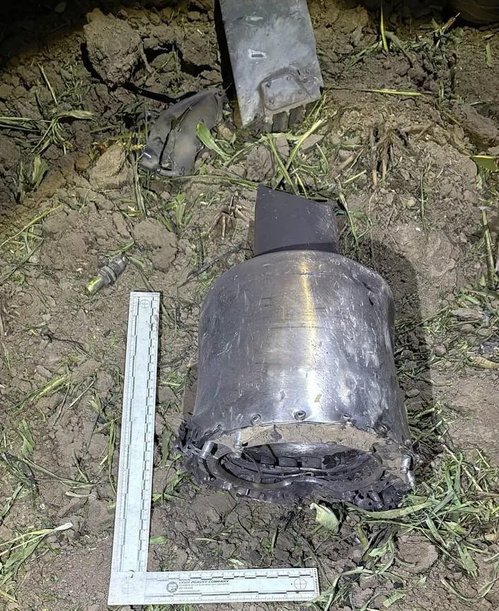 Metal wreckage from an unidentified aerial object lies beside a forensic measuring scale in a cornfield near Talmaza, Moldova.