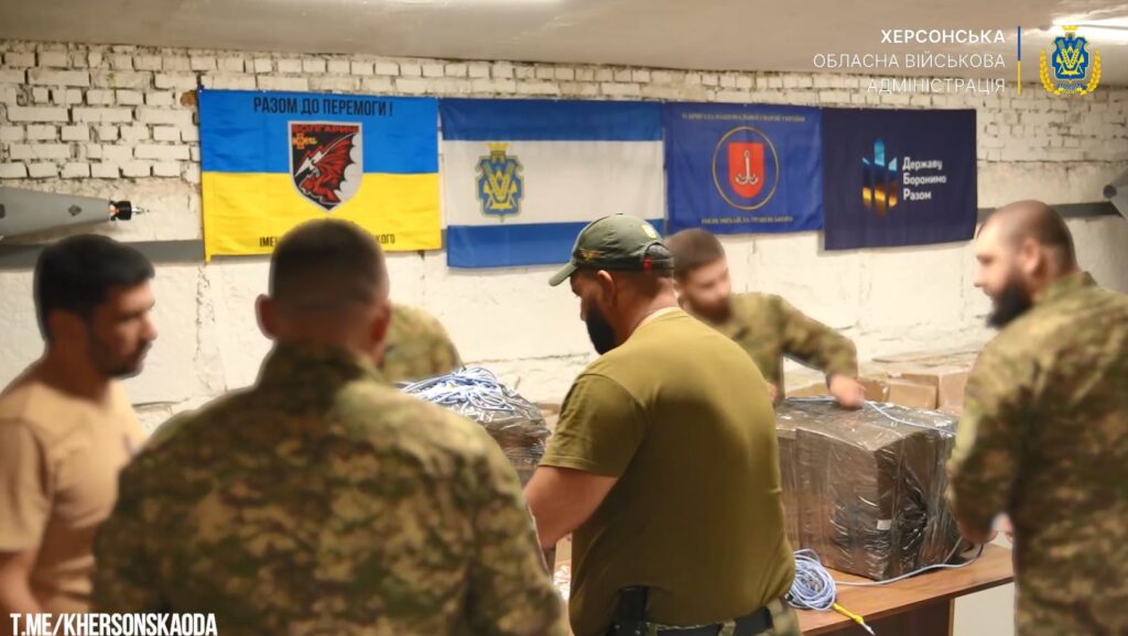russia holds 2000 people hostage oleshky without food water—ukraine flew 4000 kg locals across dnipro · post ukrainian soldiers prepare packages drone delivery occupied 2026 preparing aid boxes ukraine news