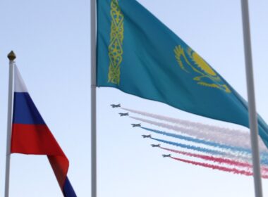 Russian and Kazakh flags fly as plane contrails form the Russian tricolour above Astana, Kazakhstan, 27 November 2024. Photo via Wikimedia Commons