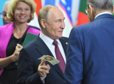 russia's 2026 deficit nearly doubles record $88 billion its new budget plans three more years red · post russian president vladimir putin brics summit kazan 23 2024 holding commemorative banknote